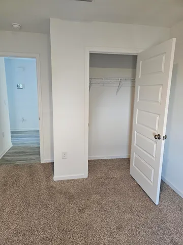 an empty room that has a grey walls