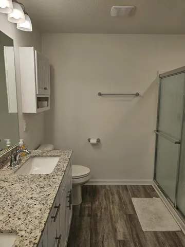 a bathroom with a granite countertop sink and a mirror