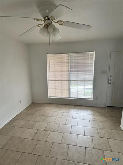 4305 Deek Drive, Unit C Killeen, TX 76549 - Photo 4 of 11 an empty room with windows and fan