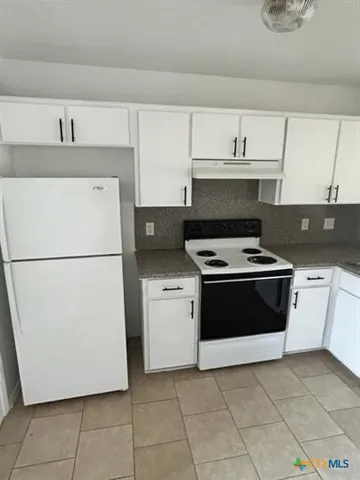 a kitchen with a cabinets and a stove