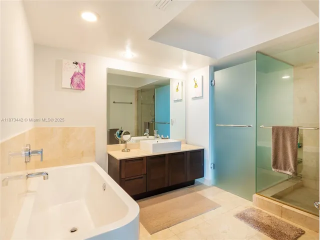 a bathroom with a bathtub sink and mirror