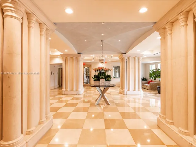 a view of a hallway with a dining table & chairs