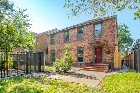 a view of a house with a small yard and plants