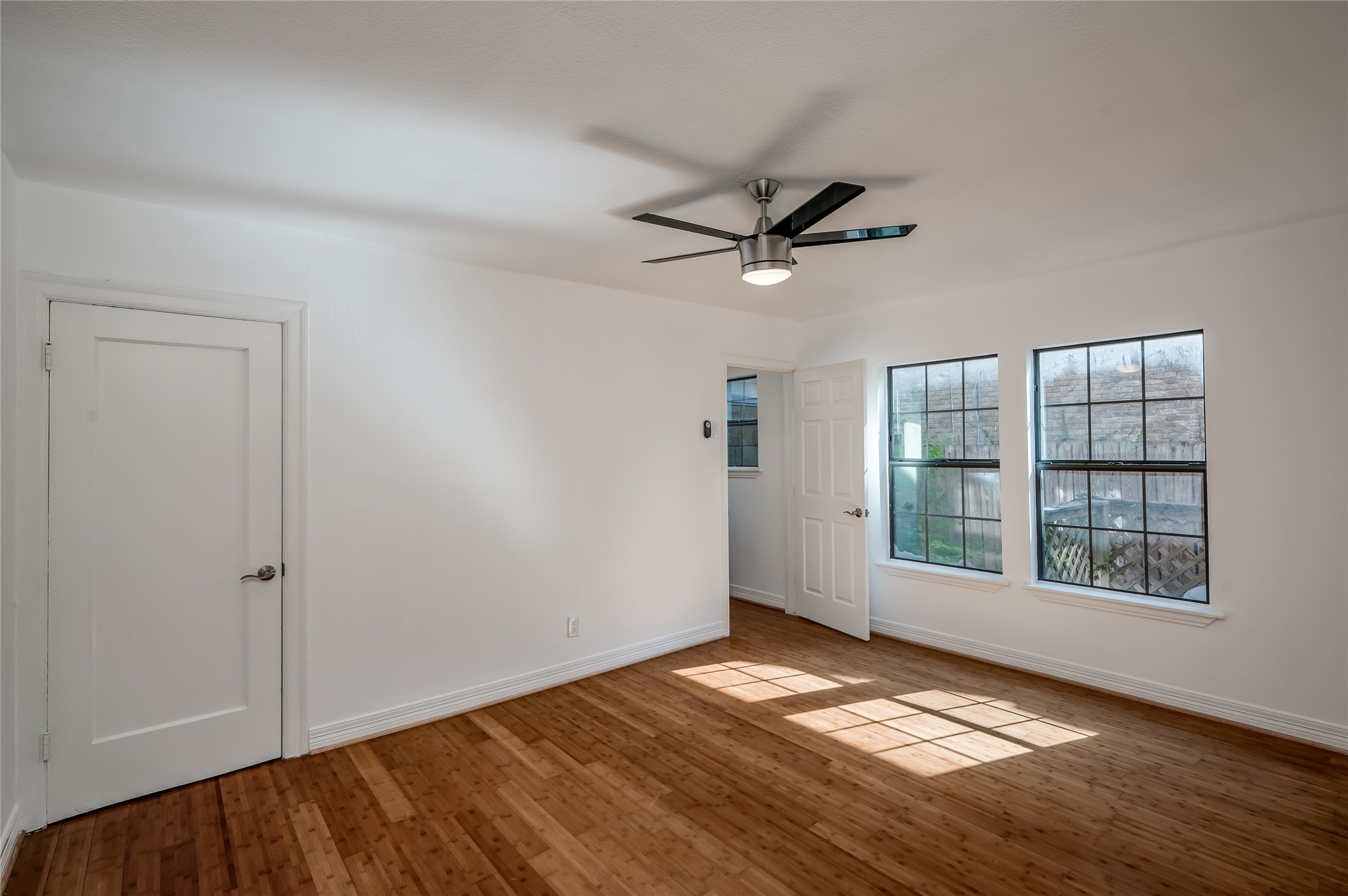 2308 Blodgett Street Houston, TX 77004 - Photo 17 of 23 an empty room with wooden floor and windows