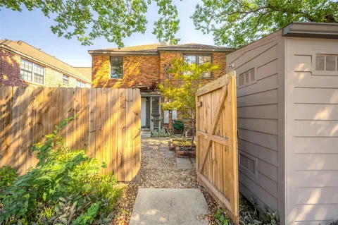 a view of a back yard with a wooden fence