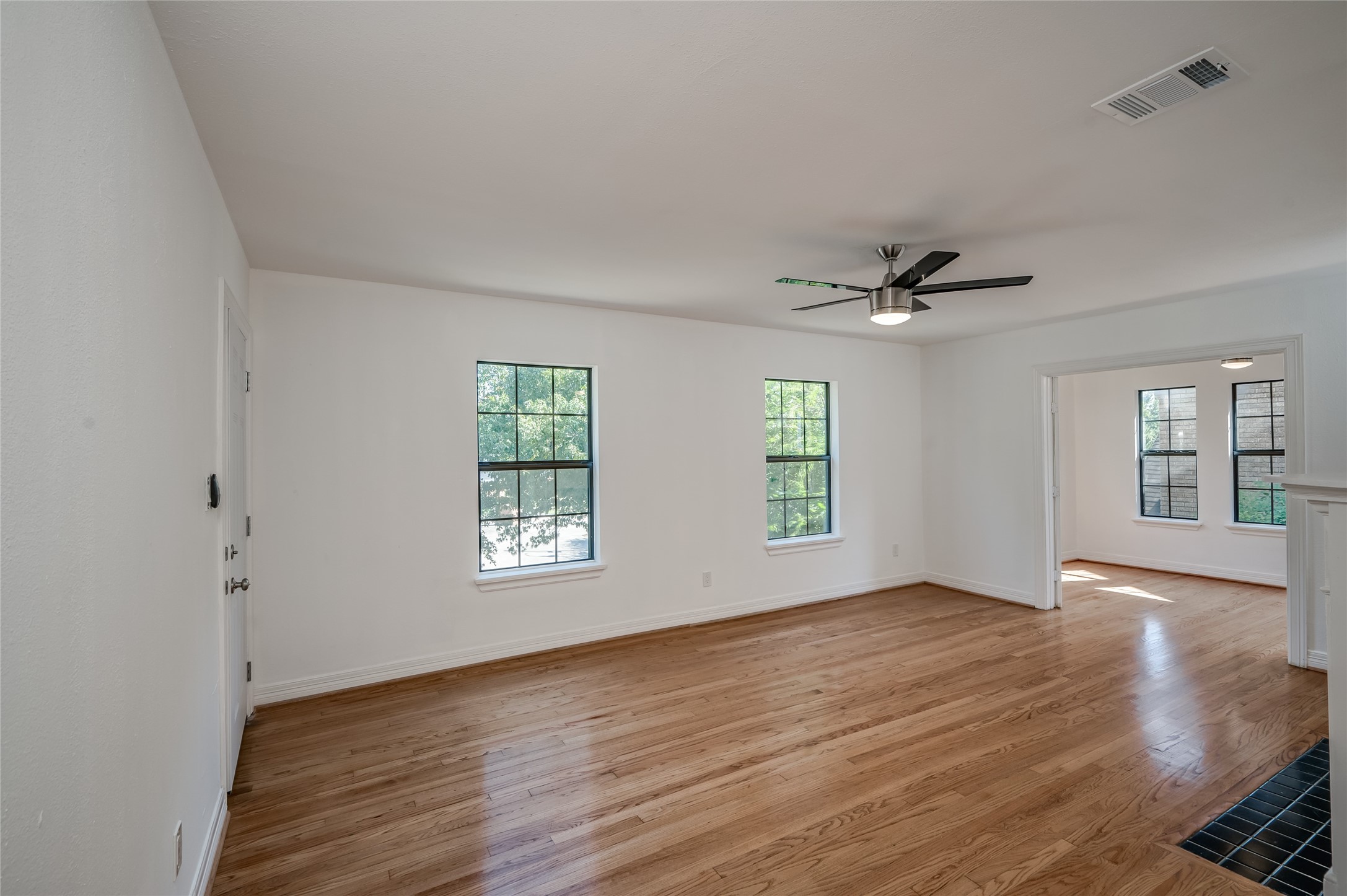 2308 Blodgett Street Houston, TX 77004 - Photo 9 of 23 a view of an empty room with a window and wooden floor