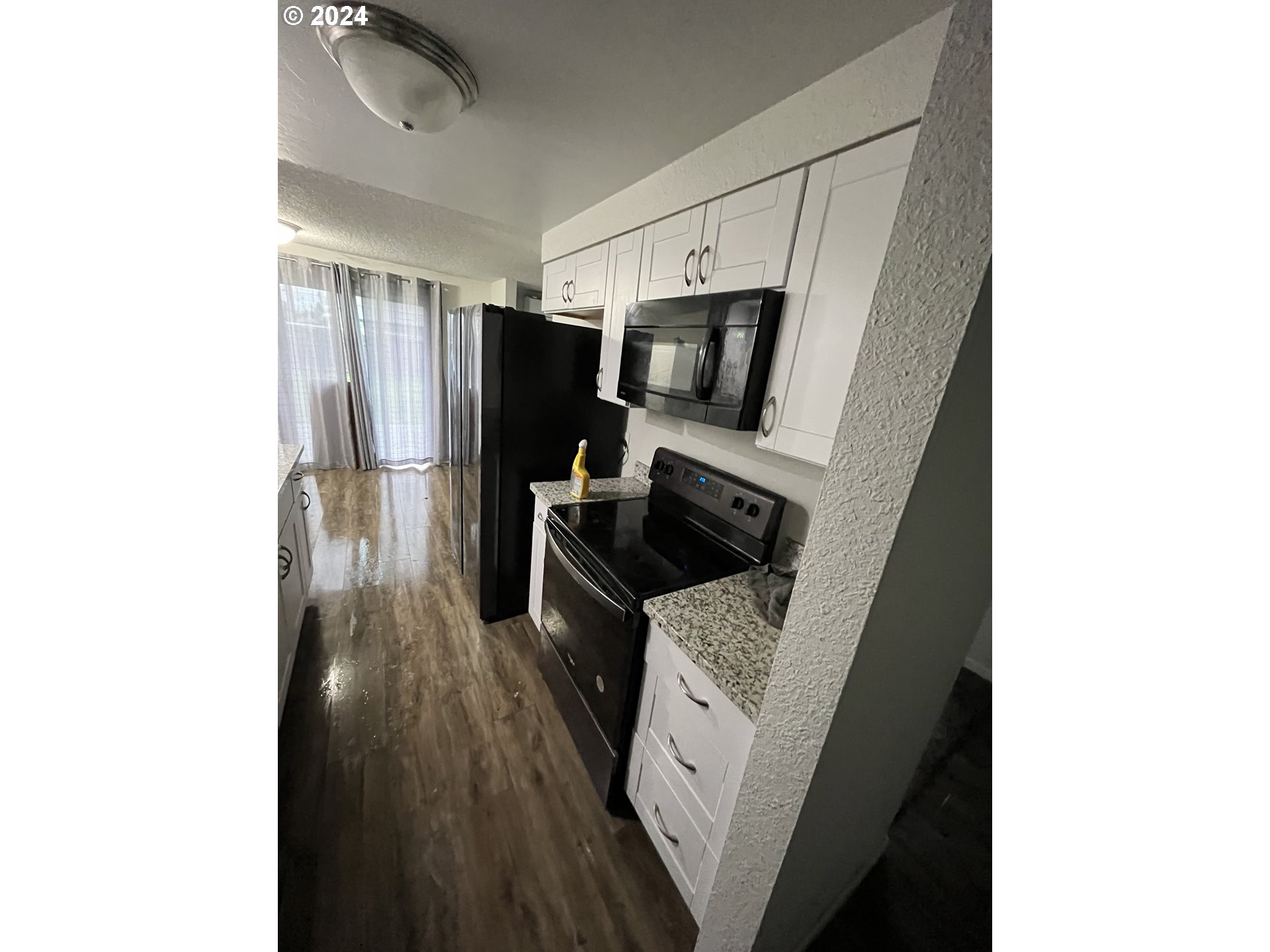 307 32nd Street Springfield, OR 97478 - Photo 3 of 8 a kitchen with a refrigerator and a stove