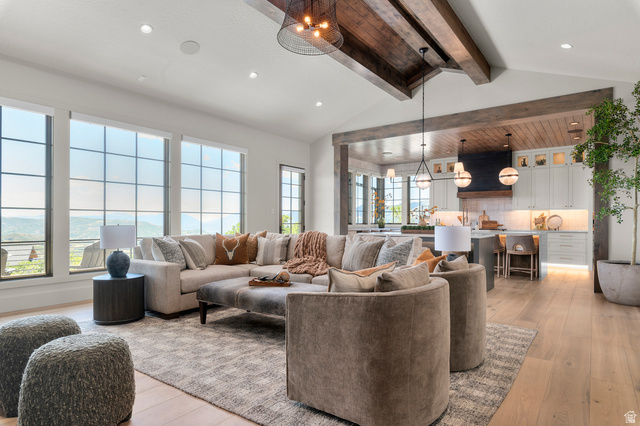 2192 East Outlaw Road Kamas, UT 84036 - Photo 6 of 80 Vaulted ceilings with exposed wood beams, expansive grid-pattern windows, light wood-finish flooring, recessed lighting, and kitchen with under-cabinet lighting