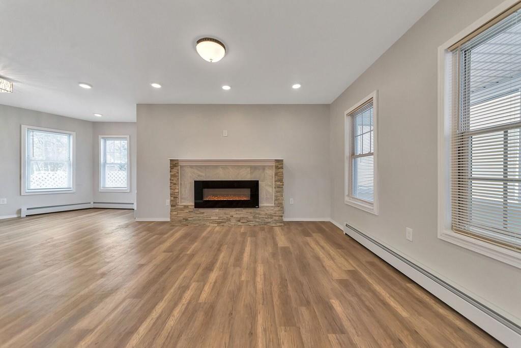 402 Allen Street Springfield, MA 01118 - Photo 13 of 28 an empty room with windows and fireplace