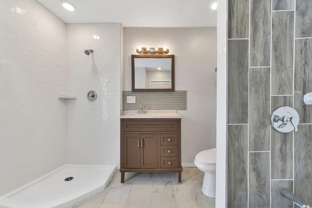 402 Allen Street Springfield, MA 01118 - Photo 20 of 28 a bathroom with a sink a toilet and a mirror