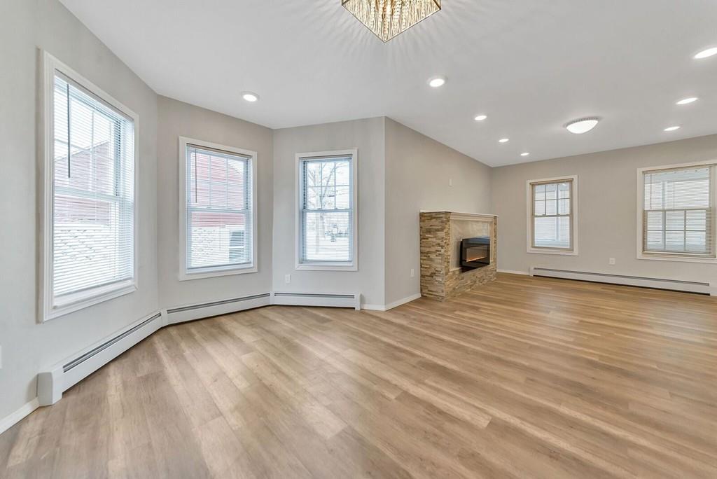 402 Allen Street Springfield, MA 01118 - Photo 10 of 28 an empty room with windows and fireplace