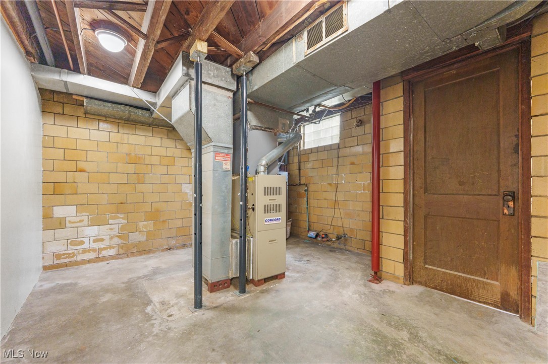 1703 Ferndale Road Northwest Canton, OH 44709 - Photo 28 of 34 Unfinished below grade area featuring concrete block wall and heating unit