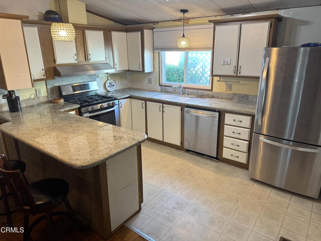 1220 Johnson Drive, Unit 131 Ventura, CA 93003 - Photo 2 of 3 a kitchen with stainless steel appliances granite countertop a sink window and cabinets