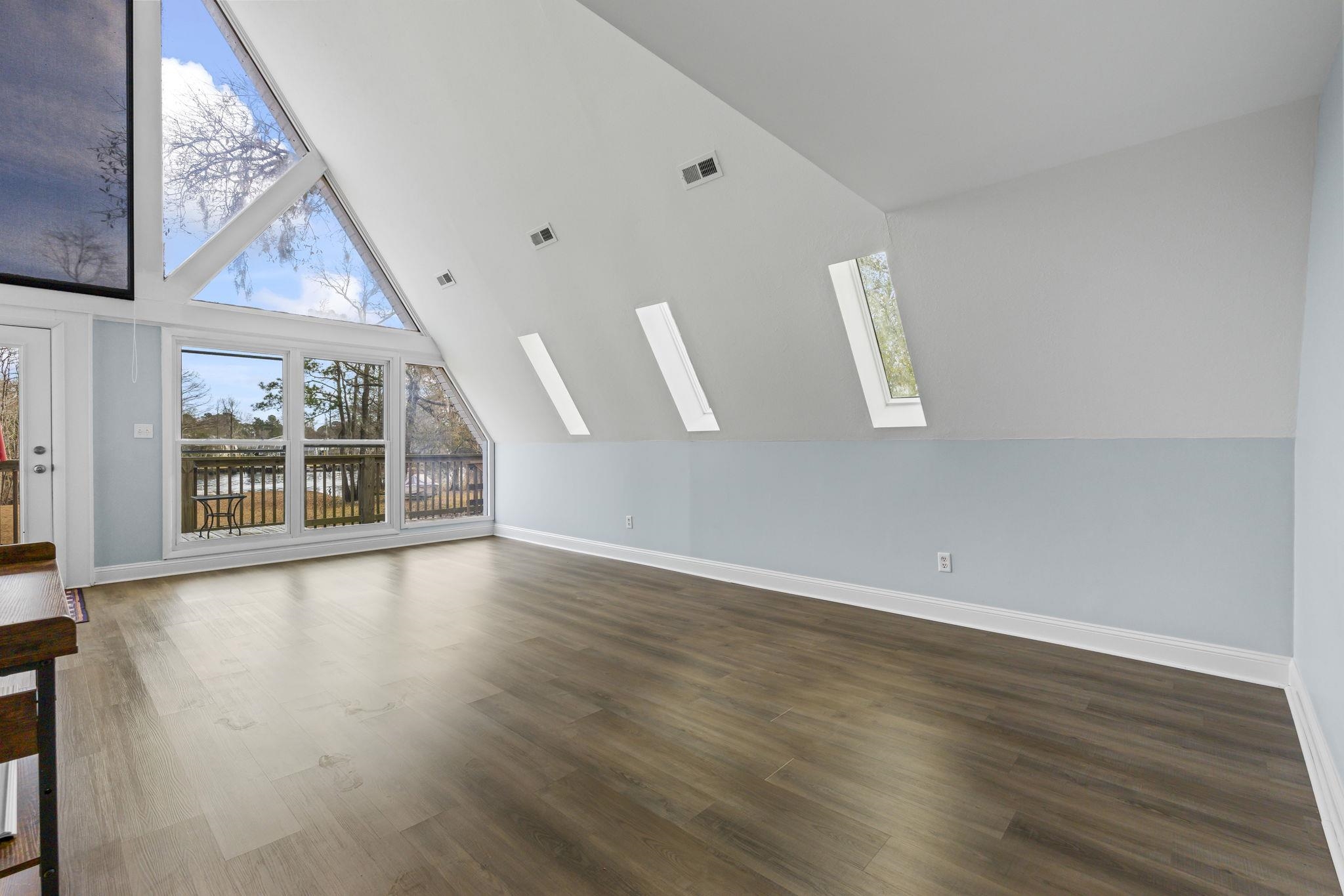 3700 Ed Smith Avenue Myrtle Beach, SC 29588 - Photo 16 of 39 Living space with a skylight, and high vaulted ceiling