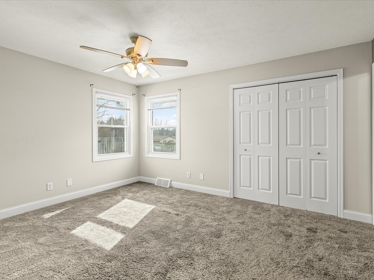 4361 Pfister Lane Roscoe, IL 61073 - Photo 16 of 41 an empty room with windows and fan