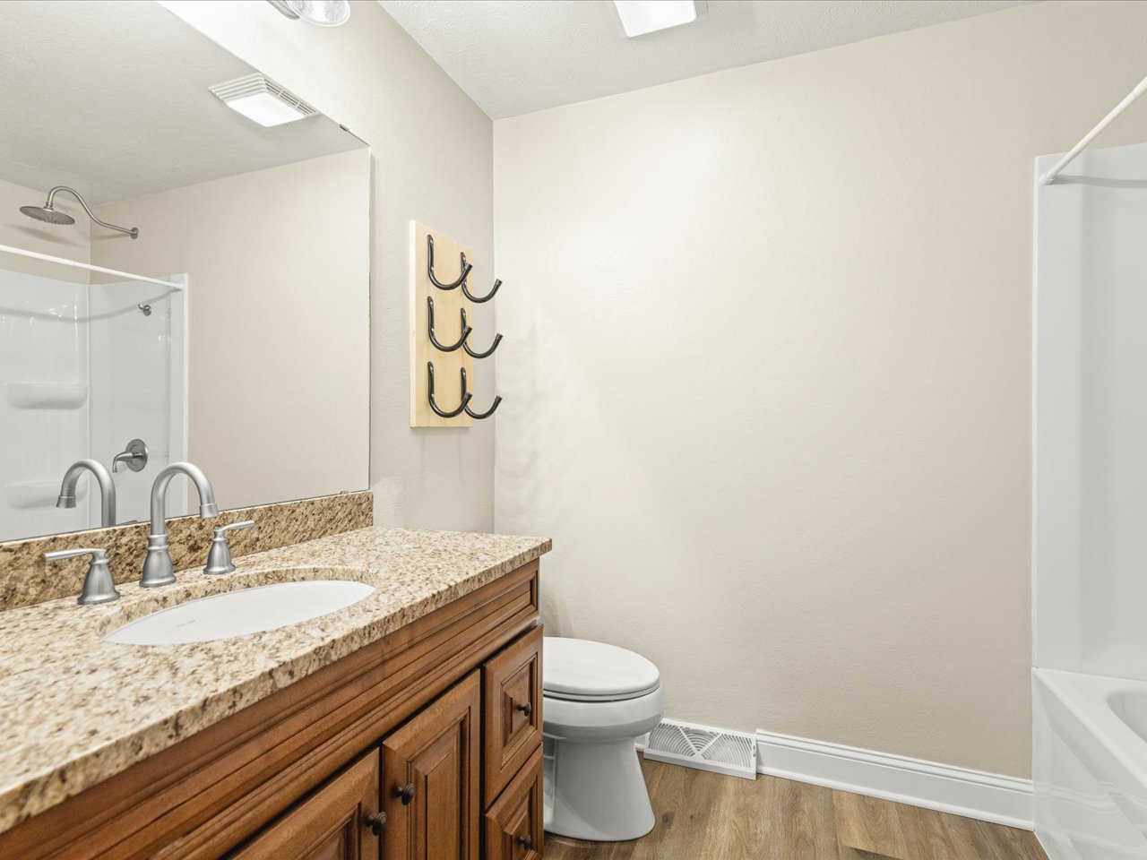 4361 Pfister Lane Roscoe, IL 61073 - Photo 23 of 41 a bathroom with a granite countertop sink a toilet and a mirror