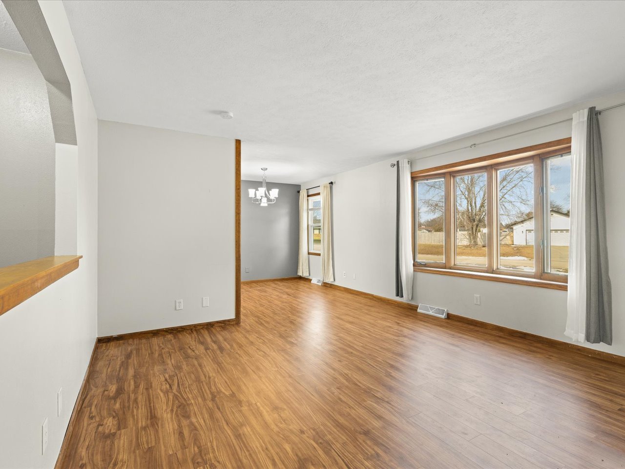 4361 Pfister Lane Roscoe, IL 61073 - Photo 5 of 41 a view of an empty room with wooden floor and a window