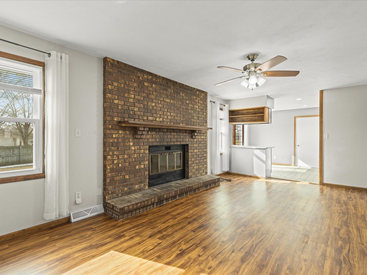 4361 Pfister Lane Roscoe, IL 61073 - Photo 6 of 41 a view of an empty room with a fireplace and a window
