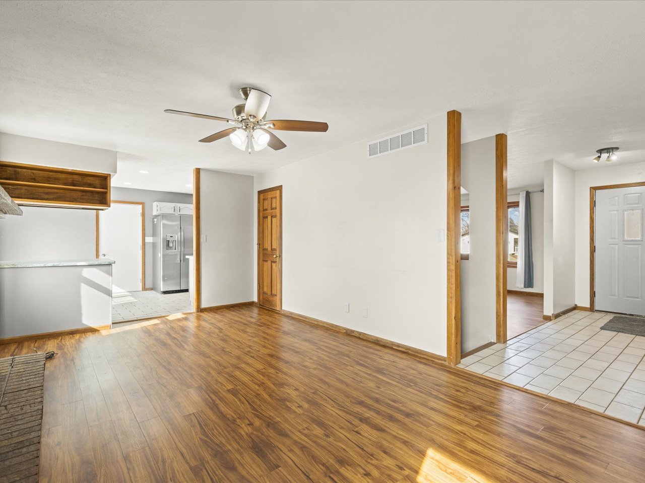4361 Pfister Lane Roscoe, IL 61073 - Photo 7 of 41 a view of a livingroom with wooden floor and a ceiling fan