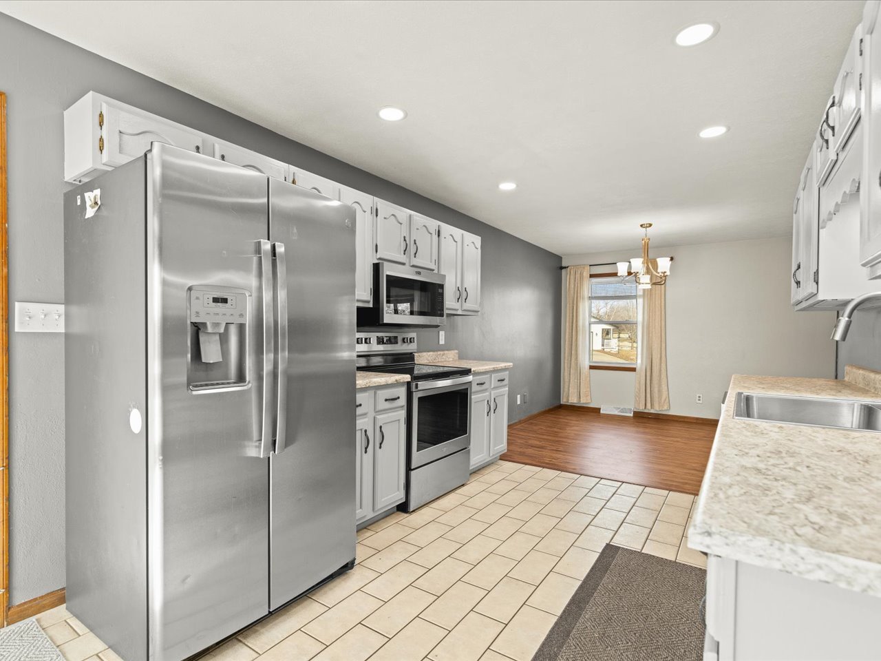 4361 Pfister Lane Roscoe, IL 61073 - Photo 10 of 41 a kitchen with stainless steel appliances granite countertop a refrigerator and a sink