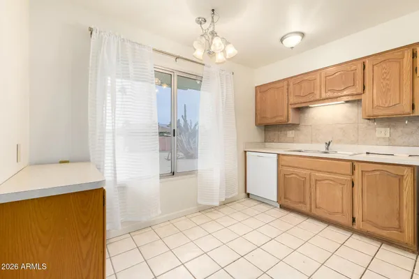 a kitchen with a sink window and cabinets