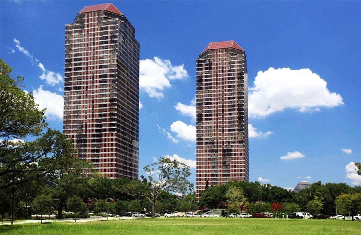 a front view of a residential apartment building with a yard