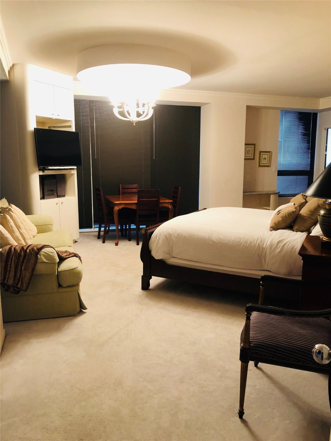 5110 San Felipe Street, Unit 273 Houston, TX 77056 - Photo 7 of 19 a bedroom with a bed and a flat screen tv