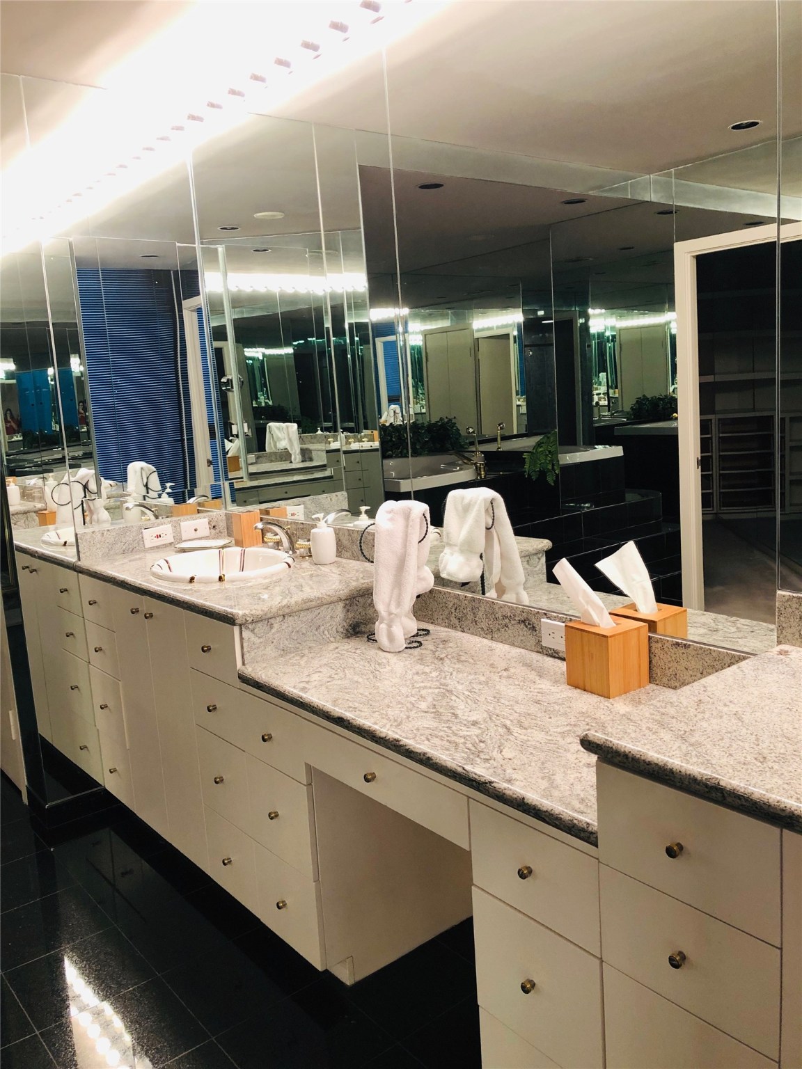 5110 San Felipe Street, Unit 273 Houston, TX 77056 - Photo 9 of 19 a bathroom with a granite countertop sink a large mirror and shower
