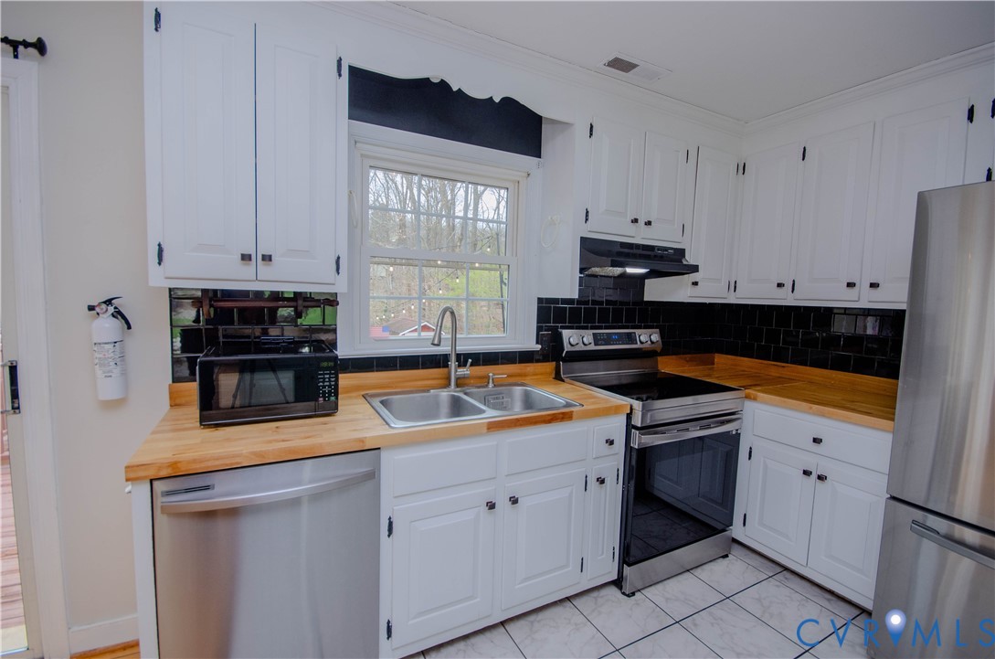 2231 Fall Line Drive Powhatan, VA 23139 - Photo 12 of 23 Kitchen with wooden counters, stainless steel appl