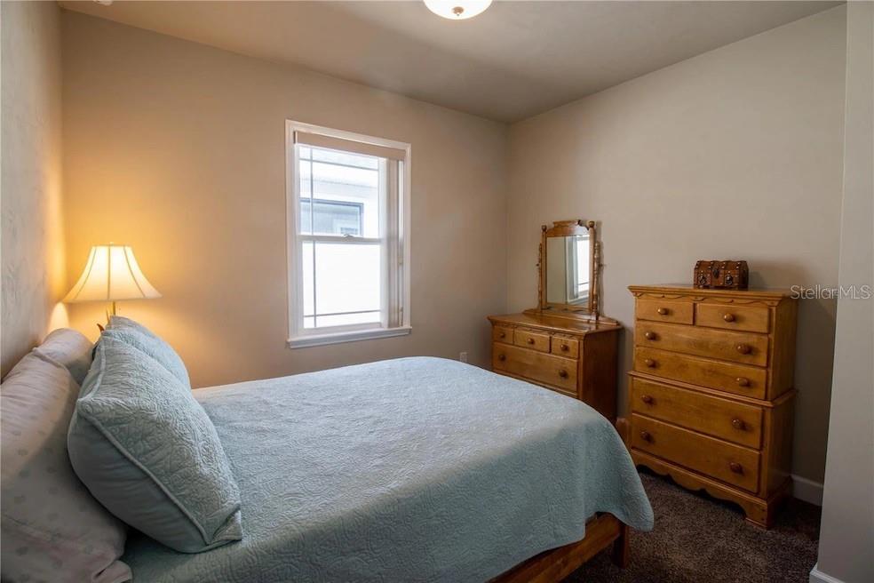 24650 Southwest 17th Place Newberry, FL 32669 - Photo 17 of 19 a bedroom with a bed and dresser with mirror