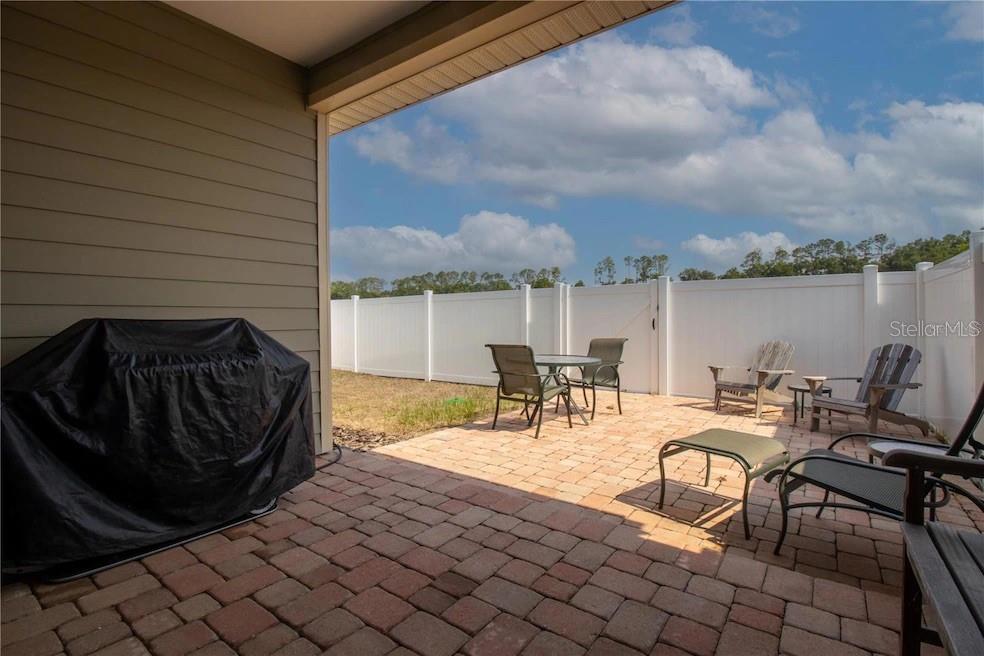 24650 Southwest 17th Place Newberry, FL 32669 - Photo 19 of 19 a view of a swimming pool with chairs and table in the patio