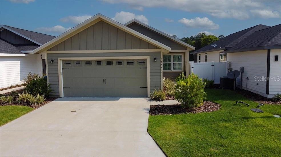 24650 Southwest 17th Place Newberry, FL 32669 - Photo 2 of 19 a front view of a house with a garden