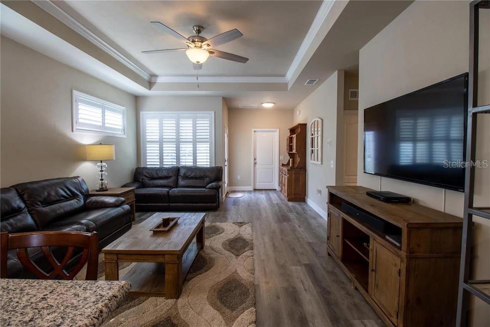 24650 Southwest 17th Place Newberry, FL 32669 - Photo 5 of 19 a living room with furniture and a flat screen tv
