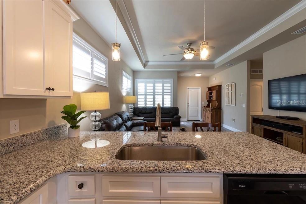 24650 Southwest 17th Place Newberry, FL 32669 - Photo 10 of 19 a kitchen with stainless steel appliances granite countertop a sink a stove and a wooden cabinets