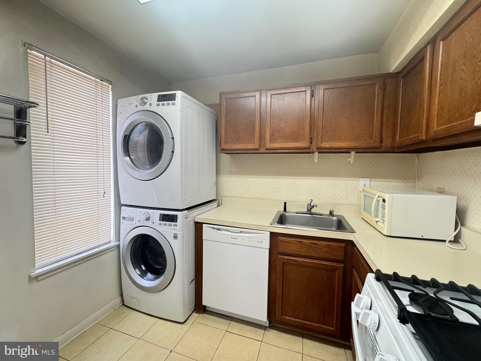 5482 Cedar Lane, Unit B2 Columbia, MD 21044 - Photo 11 of 23 a kitchen with a stove top oven sink and cabinets