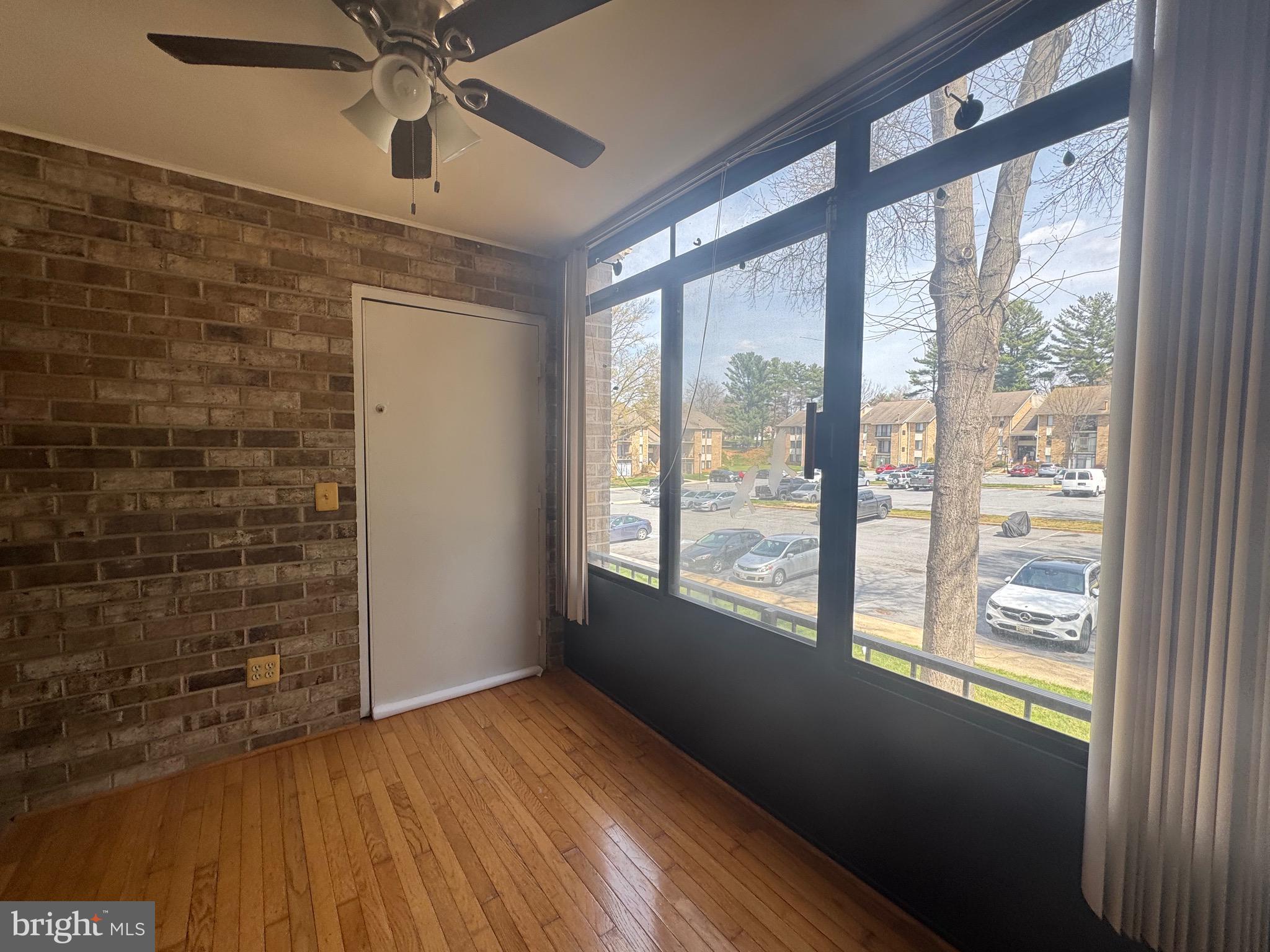 5482 Cedar Lane, Unit B2 Columbia, MD 21044 - Photo 12 of 23 a view of an empty room with a window and wooden floor