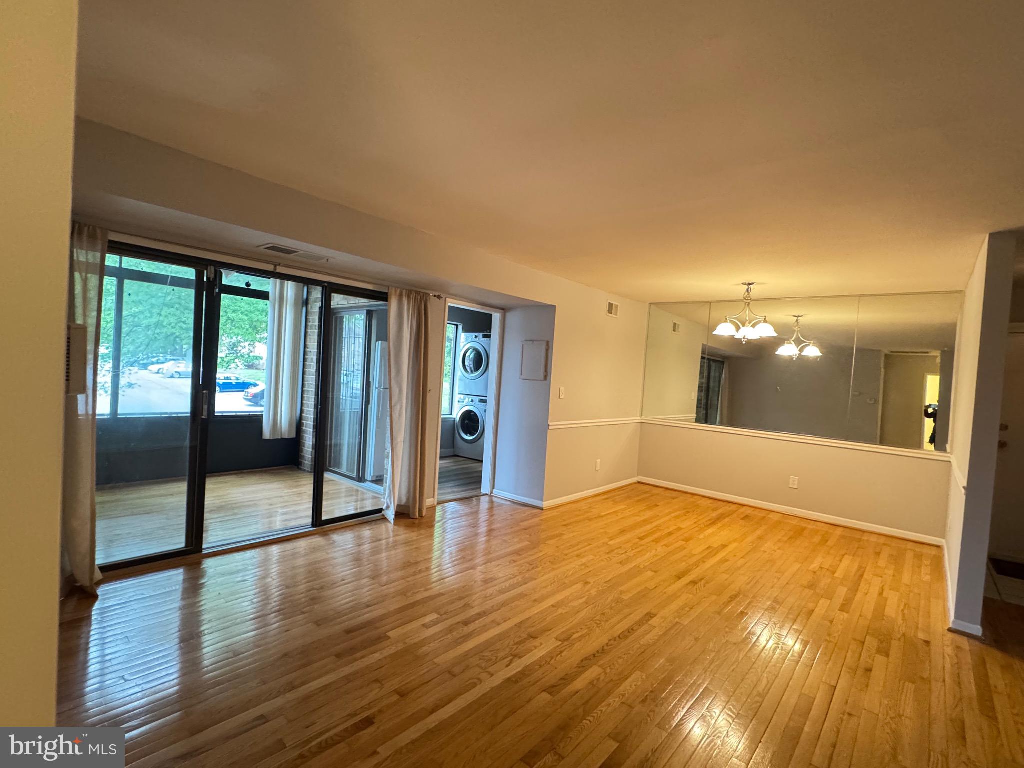 5482 Cedar Lane, Unit B2 Columbia, MD 21044 - Photo 21 of 23 wooden floor in an empty room with a window