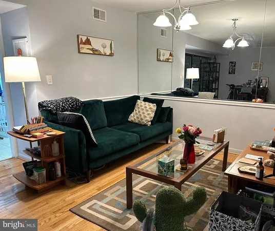 a living room with furniture a rug and a chandelier
