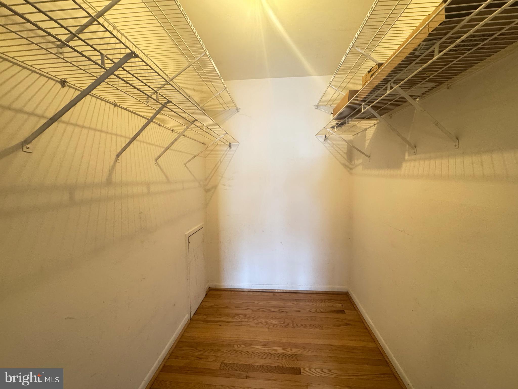 5482 Cedar Lane, Unit B2 Columbia, MD 21044 - Photo 7 of 23 a view of a room with wooden floor and brick walls