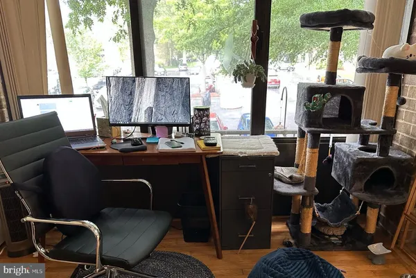 a living room with furniture a flat screen tv and a floor to ceiling window
