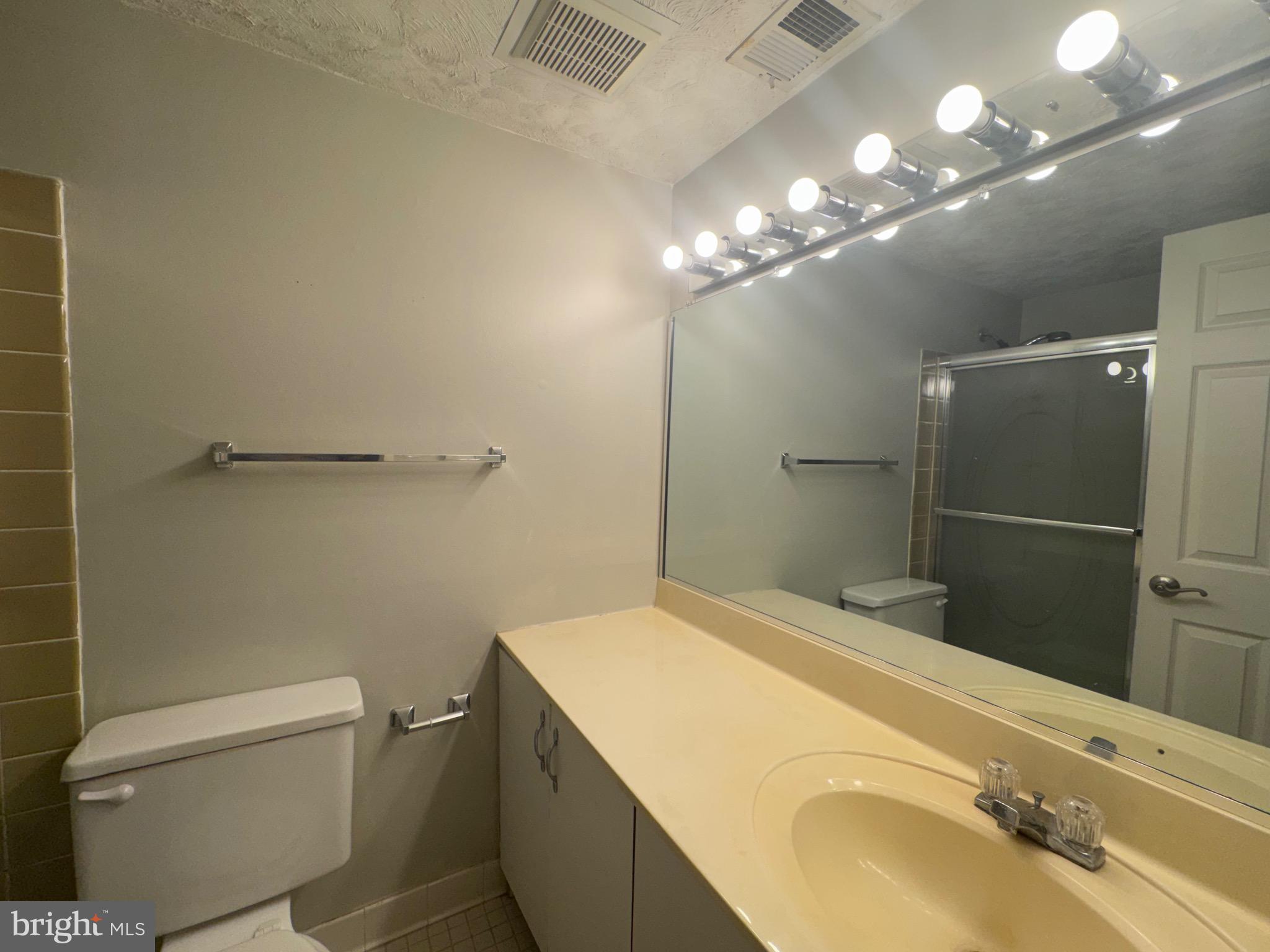 5482 Cedar Lane, Unit B2 Columbia, MD 21044 - Photo 8 of 23 a bathroom with a sink toilet and shower