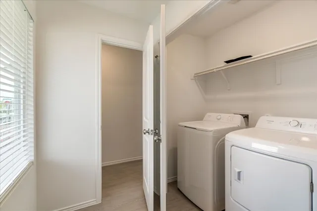 a view of storage and utility room with washer and dryer