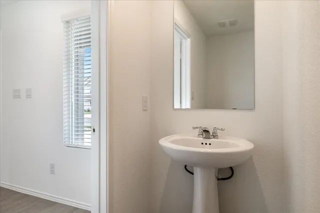a bathroom with a sink a mirror and shower