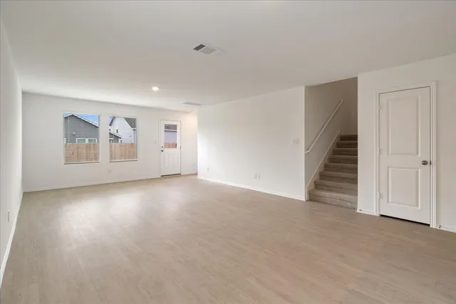 an empty room with windows and pillars in it