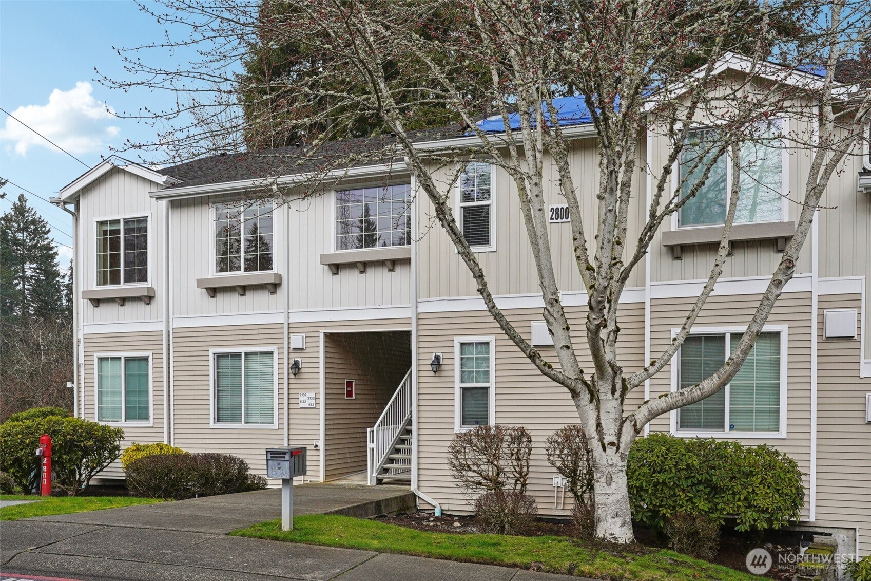 2800 Southeast 8th Street, Unit 2132 Renton, WA 98058 - Photo 3 of 24 a front view of a house with a yard