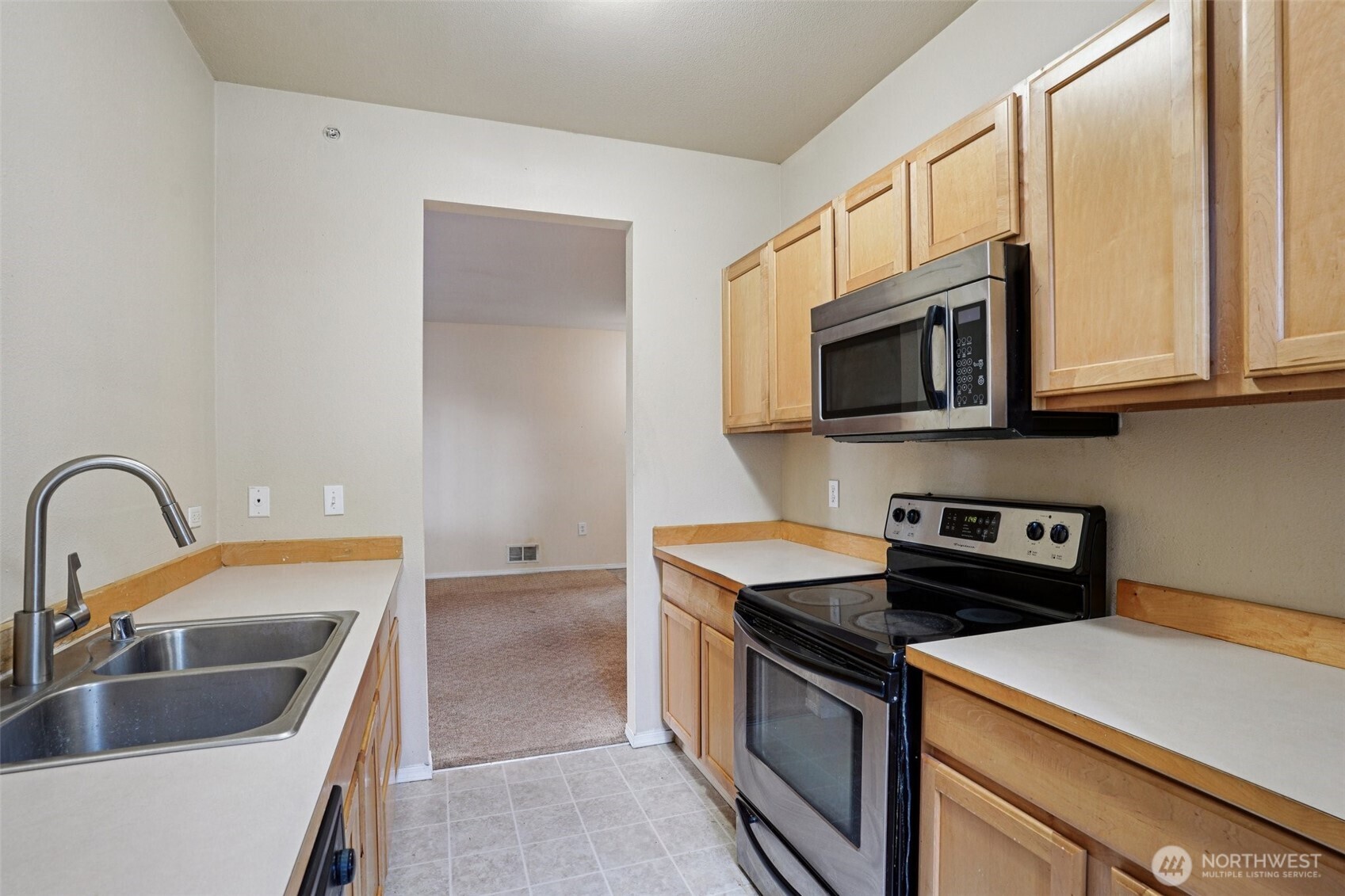 2800 Southeast 8th Street, Unit 2132 Renton, WA 98058 - Photo 7 of 24 a kitchen with stainless steel appliances granite countertop a sink a stove a microwave and refrigerator