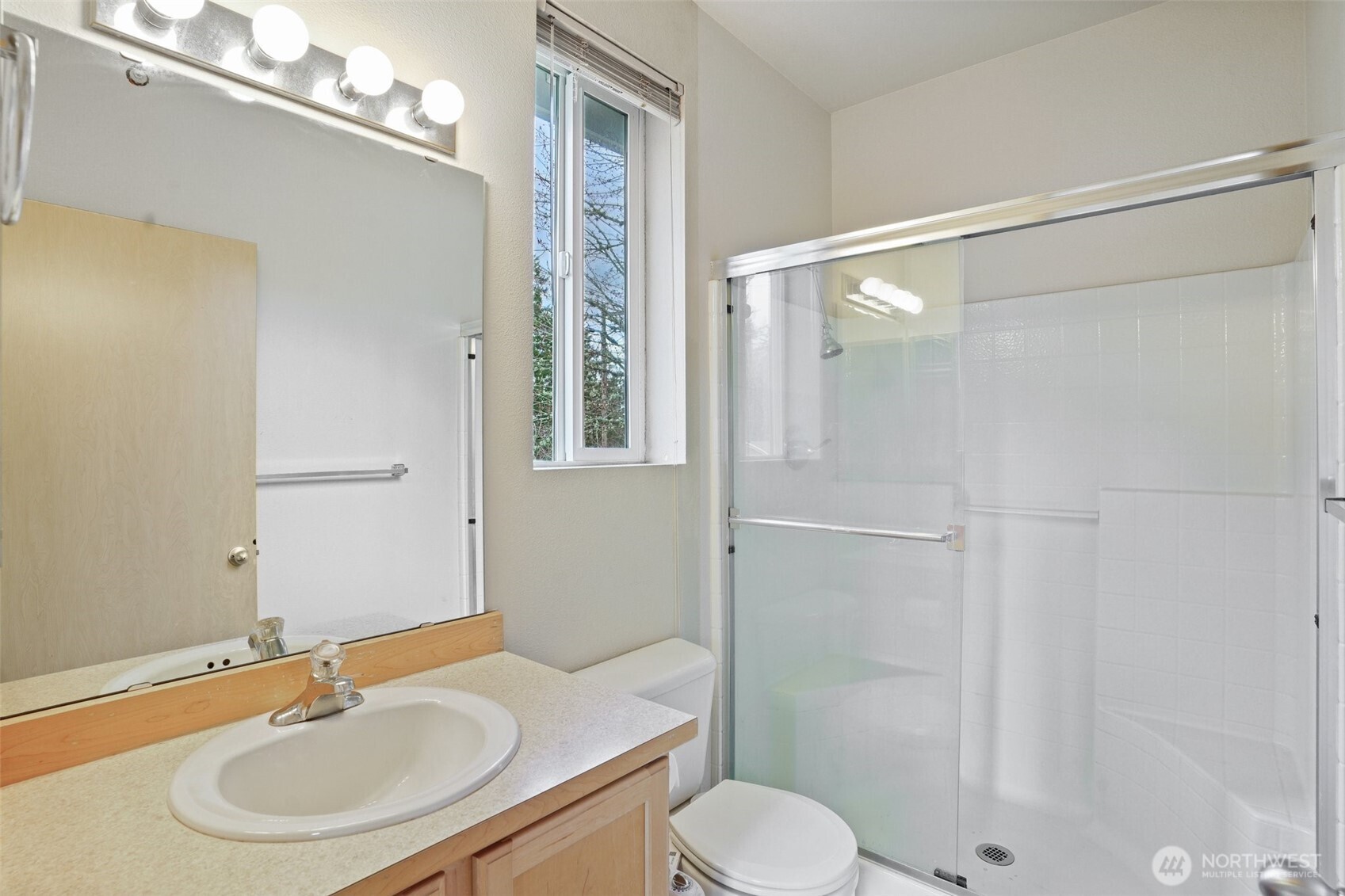 2800 Southeast 8th Street, Unit 2132 Renton, WA 98058 - Photo 10 of 24 a bathroom with a sink toilet a mirror and shower