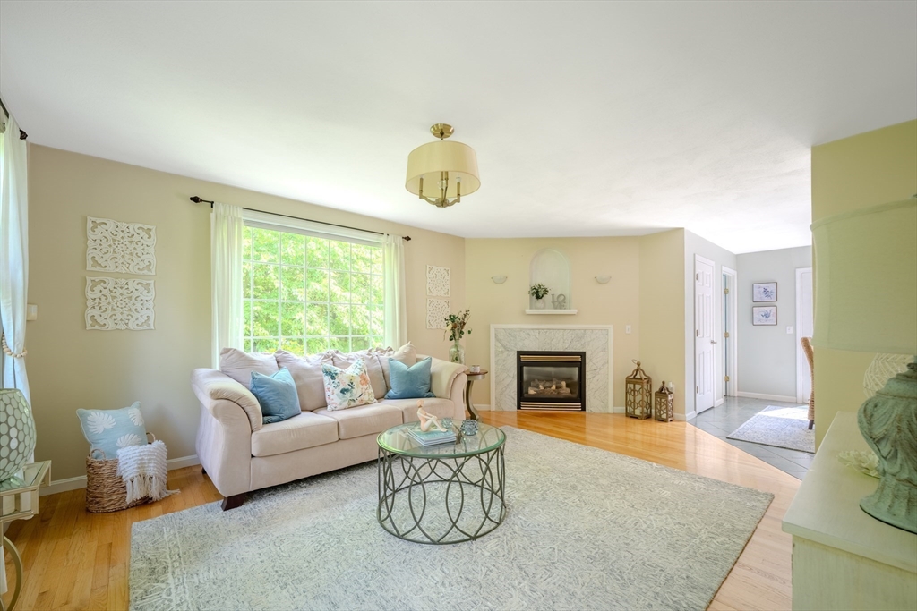 64 Jacques Road Tyngsboro, MA 01879 - Photo 11 of 39 a living room with furniture and a fireplace