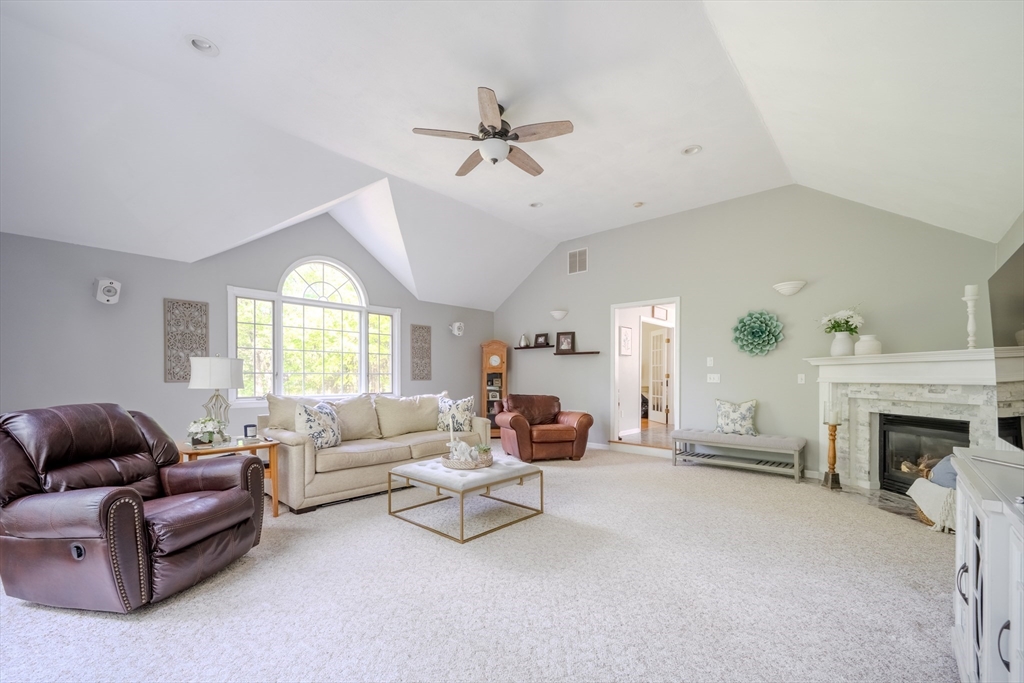 64 Jacques Road Tyngsboro, MA 01879 - Photo 14 of 39 a living room with furniture a fireplace and a large window