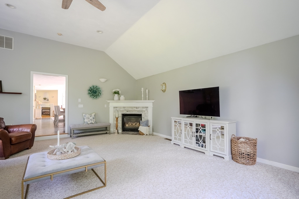 64 Jacques Road Tyngsboro, MA 01879 - Photo 16 of 39 a living room with furniture a flat screen tv and a fireplace